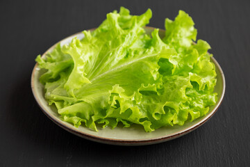 Raw Green Leaf Lettuce on a Plate, low angle view. Close-up.
