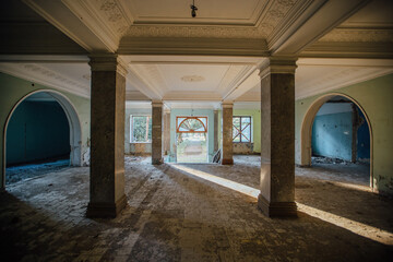 Entrance hall with columns in old abandoned mansion