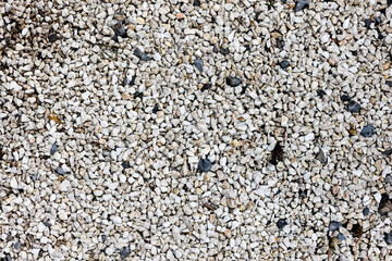 Background of grey small gravel on the pathway.