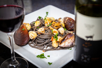 Black spaghetti with sepia squid ink with seafood, clams and shells