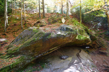Blessed Stone and sacred spring in forest near Manyava Skete in Ukraine