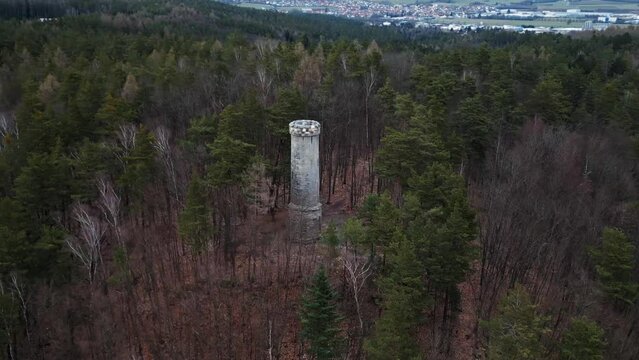 Flying around a tower in the middle of a forest in germany