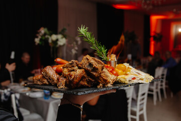 barbecue on the grill, waiter serving food in restaurant	