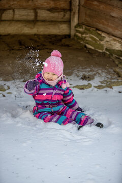 A little girl enjoys the sunny and cold winter wonderland of the north.
