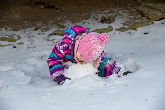 A little girl enjoys the sunny and cold winter wonderland of the north.
