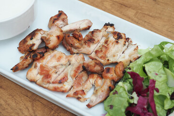 close up of slice of grill chicken on a plate 