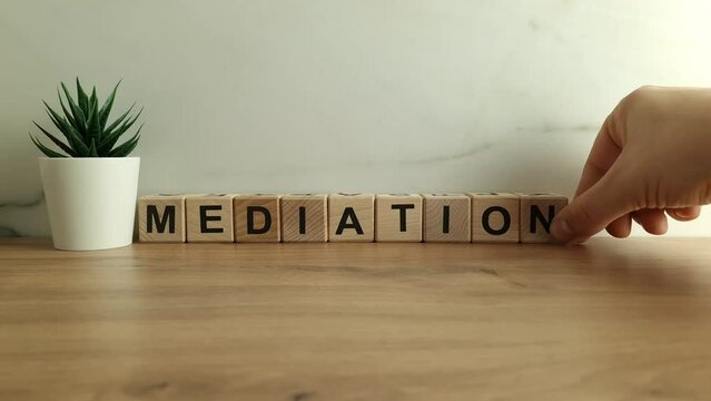 Word mediation from wooden cubes. Dispute resolution, conflict, mediator concept