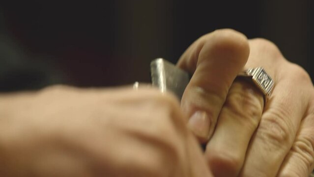 Close-up of  hands loading bullets in magazine.