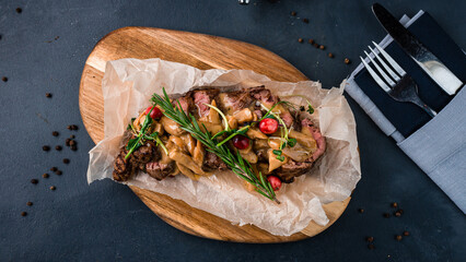 Fried beef fillet steak with champignon, cranberries, rosemary and sauce.
