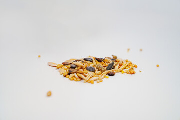 different seeds on a white table. food for poultry and rodents.