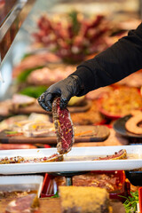 Meat department, showcase with variety of meat in different cuts. Inside an supermarket. Different types of fresh meat arranged in an orderly manner.