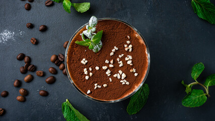 Obraz na płótnie Canvas Fresh dessert tiramisu in a bowl with nuts and mint.
