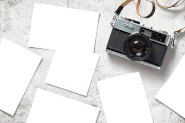 photo mockup / template with vintage analog camera and paper prints / images scattered on a white...