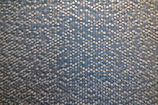 hexagonal extruded ceramic chips reflecting light and shadow