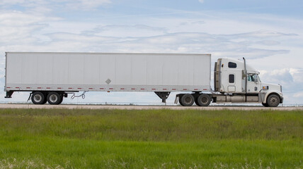 Heavy cargo on the road. A truck hauling freight along a highway. Taken in Alberta, Canada