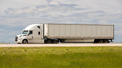 Heavy cargo on the road. A truck hauling freight along a highway. Taken in Alberta, Canada