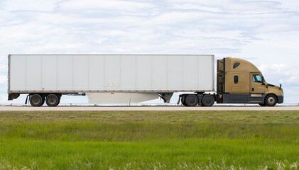 Heavy cargo on the road. A truck hauling freight along a highway. Taken in Alberta, Canada