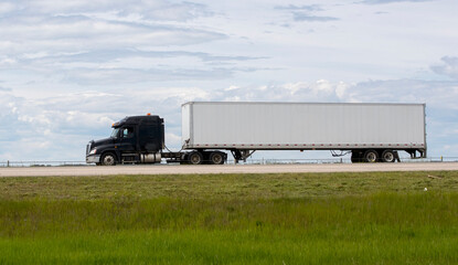 Heavy cargo on the road. A truck hauling freight along a highway. Taken in Alberta, Canada