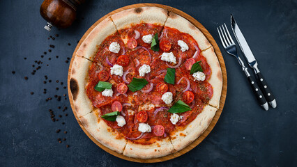 Pizza with sausage, cherry tomatoes, red onion, cream cheese, spinach and spices.