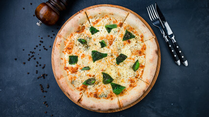 Italian cuisine pizza with cheese, greens and spices.