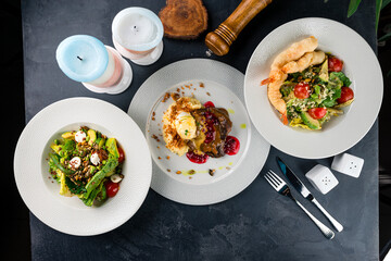 Set shrimps tempura with greens salads and beef steak with mashed potatoes and lingonberry sauce.