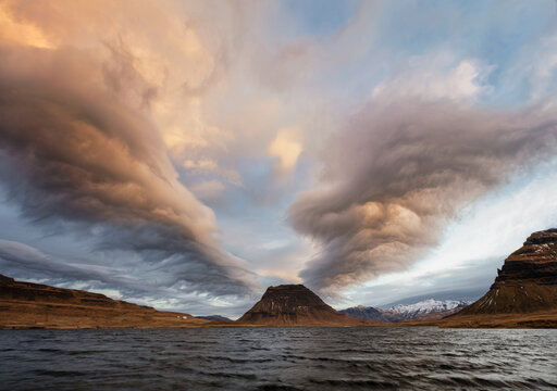 Wing shaped clouds over Kirkjufell mountain in Iceland