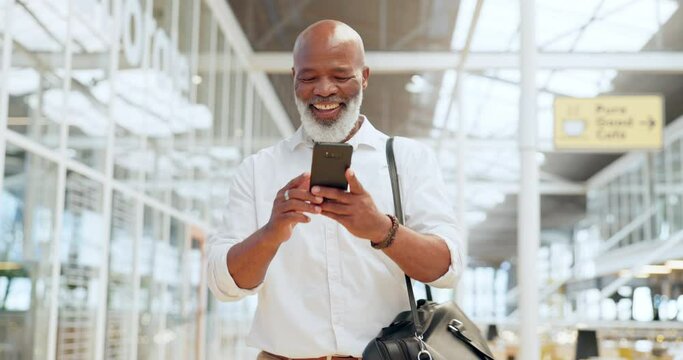 Phone, walking and good news with a black man in an airport for travel, tourist or a holiday getaway. Mobile, contact and traveling with a senior male typing a text message while in a terminal
