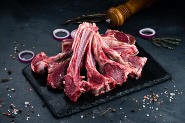 Raw beef ribs for grilling with spices and salt.