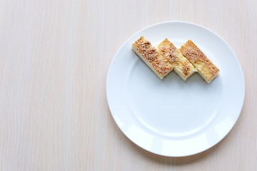 Slice of plain cheesecake on white plate and for for eating isolated on concrete background wafer biscuit on white background. High quality photo