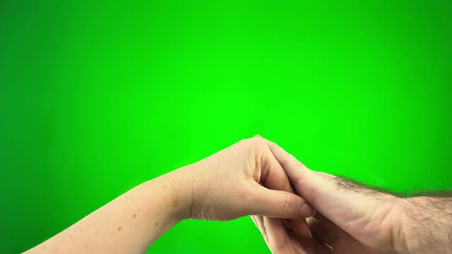 woman gives a hand to a man a man strokes her on a green background chromakey close-up approval pity love warm
