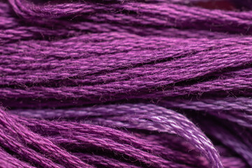 A closeup view of purple thread in a horizontal pattern.