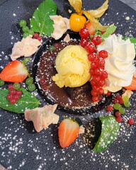 delicious dessert, chocolate brownie with ice cream and fruits