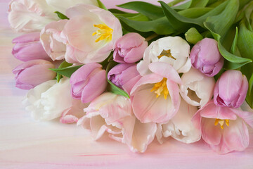 Bouquet of pink, white and purple tulips closeup on colorful watercolor paper background, beautiful postcard.