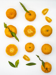 Orange fruit with green leaves on the white background. Home gardening. Mandarine oranges. Tangerine oranges. Orange color. Fresh orange juice.