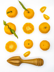 Orange fruit with green leaves on the white background. Home gardening. Mandarine oranges. Tangerine oranges. Orange color. Fresh orange juice.