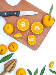 Orange fruit with green leaves on the white background. Home gardening. Mandarine oranges. Tangerine oranges. Orange color. Fresh orange juice.