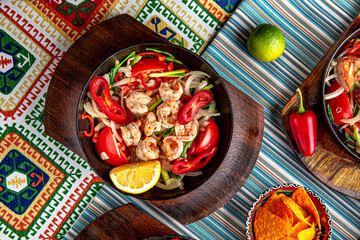 Traditional mexican food. Frying pan with hot shrimp fajitas. Colorful Food Table Celebration Delicious Party Meal Concept. 