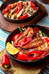 Traditional mexican food. Frying pan with hot salmon fajitas. Colorful Food Table Celebration Delicious Party Meal Concept. 
