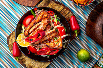 Traditional mexican food. Frying pan with hot salmon fajitas. Colorful Food Table Celebration...