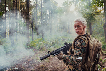 Woman soldier ready for battle wearing protective military gear and weapon