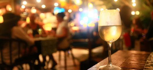 a glass of white wine in a restaurant, alcohol luxury background