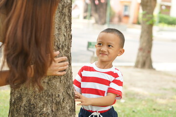 Mother and baby playing in the park happily.