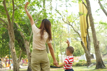 Mother and baby playing in the park happily.