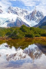 Cerro Torre, Vertical Portrait of famous mountain Peak in Chalten Range, Patagonia Argentina.  Scenic Landscape Reflection in Calm Lake on a Hiking Trail to Laguna Torre