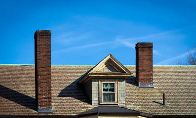 Old building gable roof brick chimneys and dormer window, Boston, MA