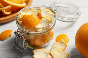 Orange peels preparing for drying on white wooden table, closeup