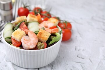 Tasty salad with croutons, tomato and capers on white textured table, closeup. Space for text