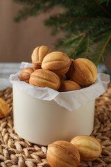 Delicious nut shaped cookies on wicker mat, closeup