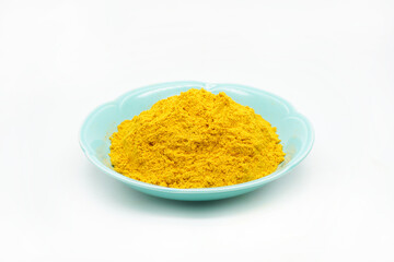 Curry powder on blue green ceramic dishes isolated on white background