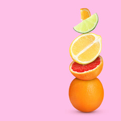 Stack of different fresh citrus fruits on pale pink background, space for text